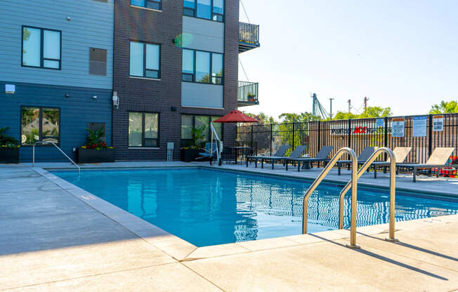 a swimming pool with a building in the background