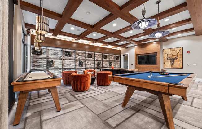 a billiards room with a pool table and tables