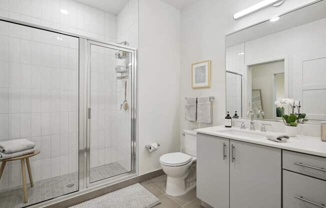 a white bathroom with a shower and a sink at Sinclaire on Seminary, Alexandria Virginia