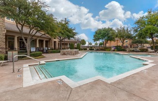 Swimming pool with lounge seating and community clubhouse