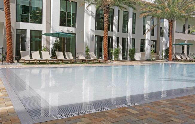 a swimming pool with a building in the background