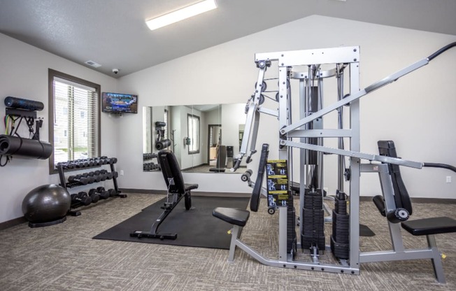 Modern gym with rows of cardio equipment.