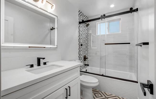 a bathroom with a shower and a sink and a mirror