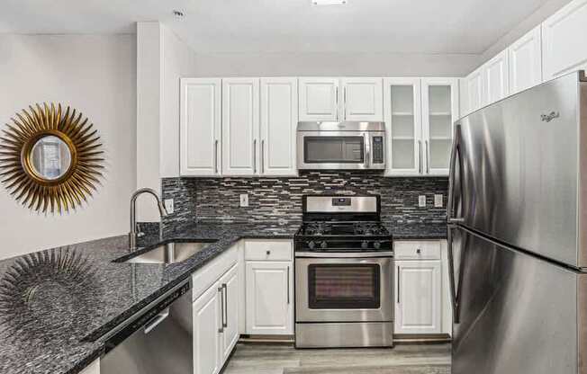 a kitchen with stainless steel appliances and white cabinets