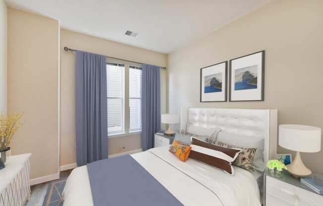 bedroom with bed, nightstands, large windows at city view apartments in washington dc