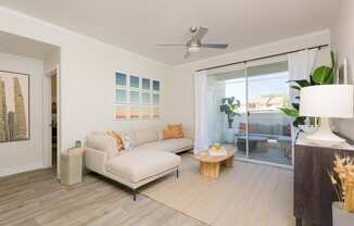 a living room with a white couch and a sliding glass door