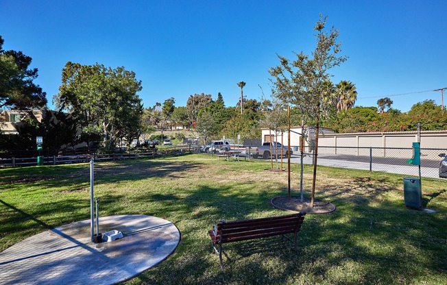 Community dog park with seating and doggy clean up station