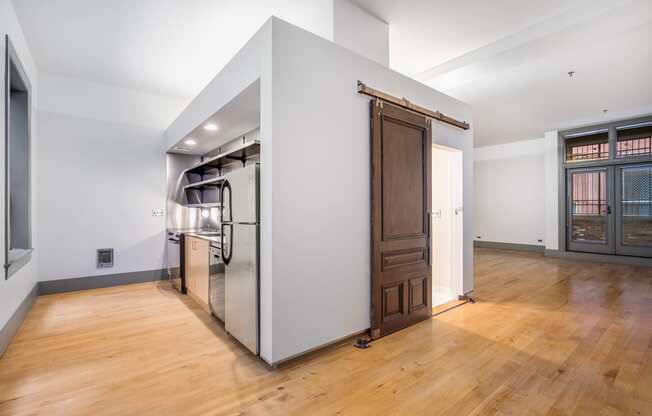 a large kitchen with a large stainless steel refrigerator and a wooden door