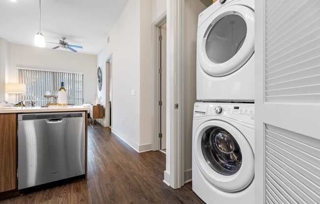 a washer and dryer in a living room with a kitchen