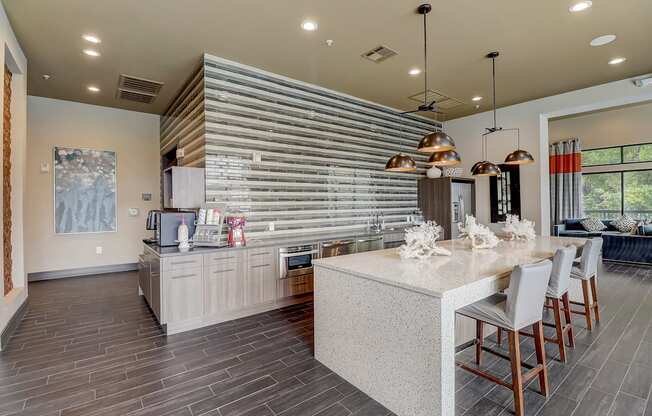 a kitchen with a large island and a table with chairs