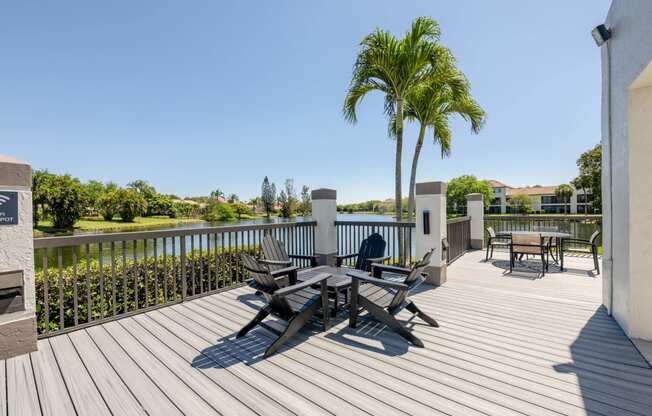 Coconut Creek Apartments – Waterview at Coconut Creek – deck has a palm tree and chairs on it