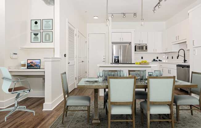 a dining room and kitchen with a table and chairs