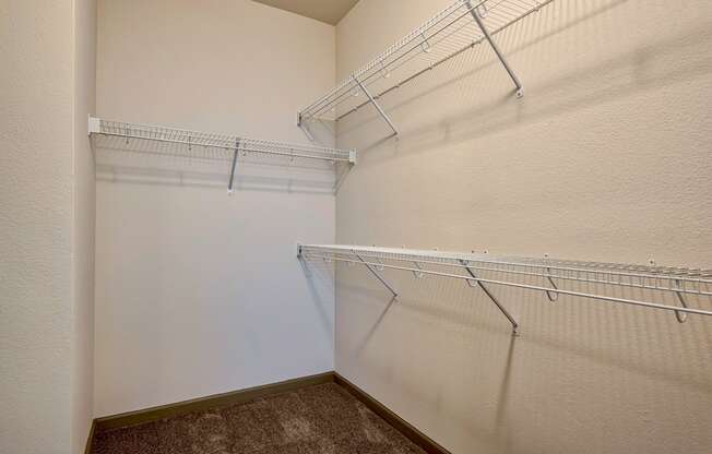 walk in closet with racks at Parc at Bentonville Apartments in Bentonville, AR