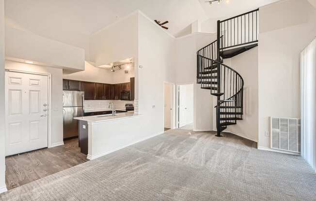 A Kitchen with a Spiral Staircase at Fox Run Lofts