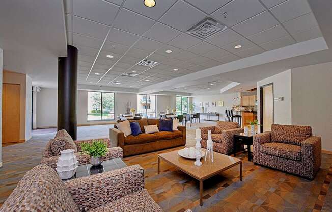 A lobby with chairs, a sofa, and a coffee table.
