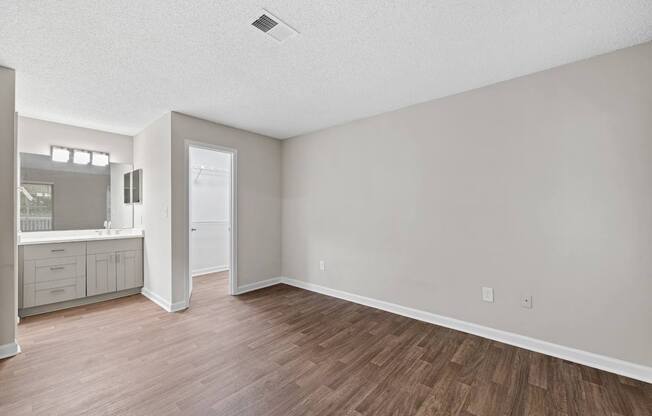 A room with a wooden floor and white walls.