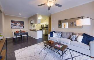A modern living room with a white couch and a coffee table.