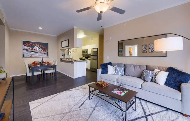 A modern living room with a white couch and a coffee table.
