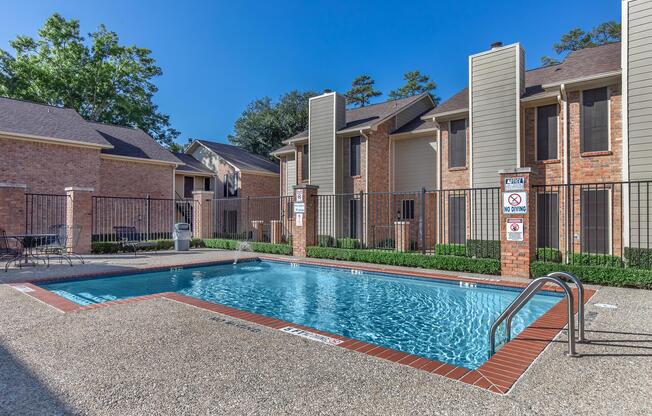 a house with a pool in front of a building