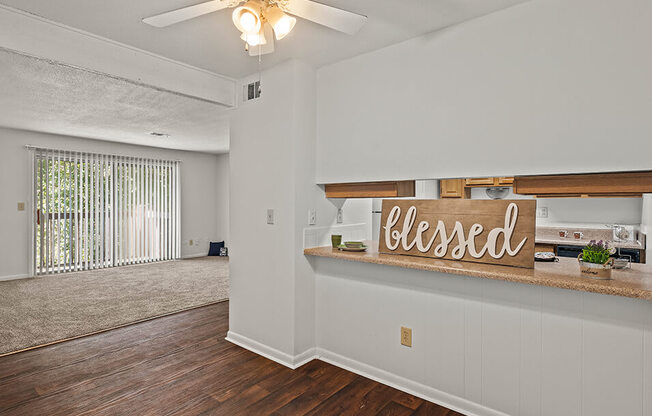 an empty living room with a closed sign on the wall