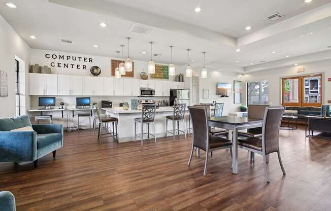 A room with a computer center and a bar area.