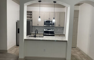 A kitchen with a granite countertop and a sink.