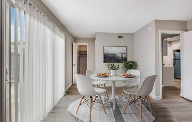 a dining room with a white table and chairs