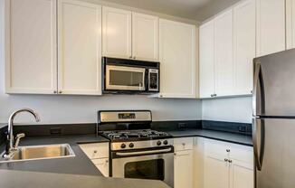 Kitchen with white cabinets and stainless steel appliances