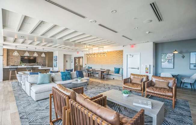 A spacious living room with a variety of seating options and a fireplace.