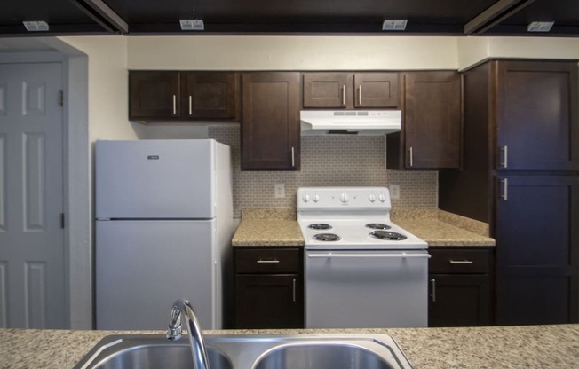 This is a photo of the kitchen of a fully upgraded 1084 square foot 2 bedroom townhome at The Biltmore Apartments in Dallas, TX.