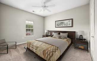 a bedroom with a bed and a ceiling fan