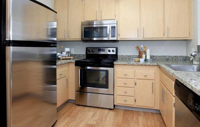 a kitchen with stainless steel appliances and wooden cabinets