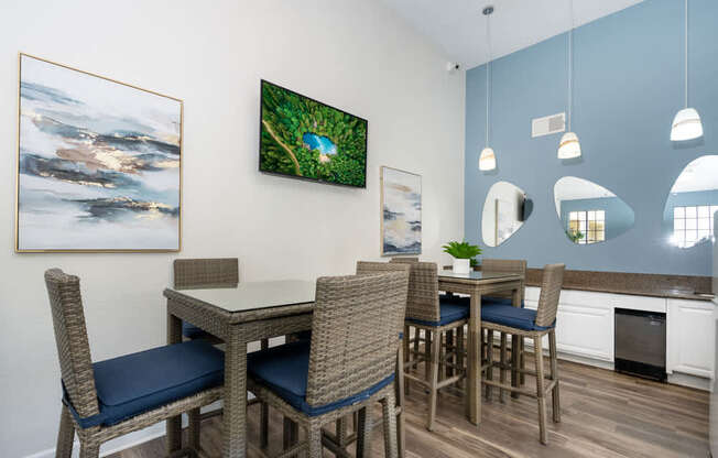 A dining room with a table and chairs.