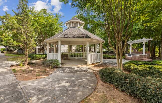 a gazebo in a park with trees