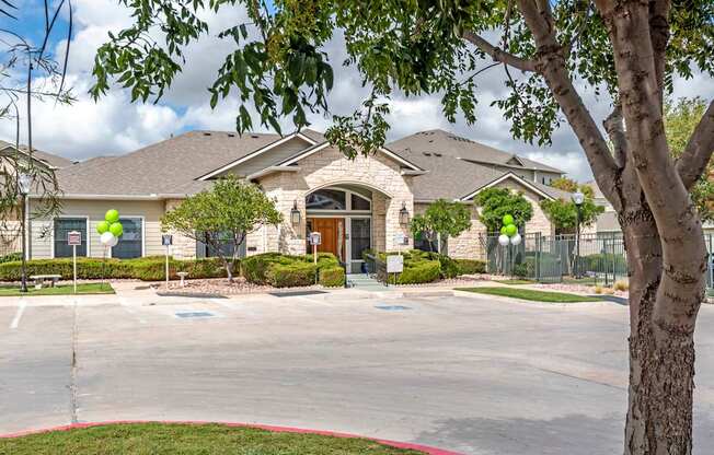 A large house with a tree in front.