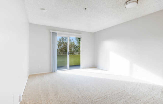 Carpeted Living Room with Balcony