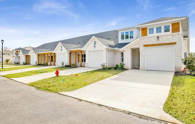 a house with a sidewalk and a fire hydrant in front of it