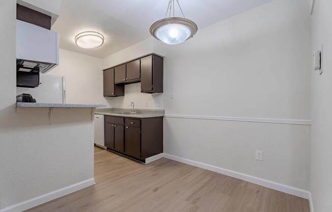 A kitchen area with a sink and cabinets.