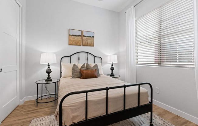 a bedroom with a bed and a large window