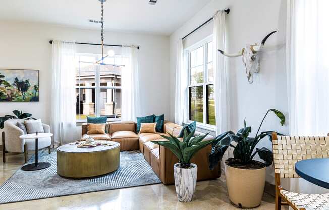 Living room with a couch and a table and some plants at The Parker Austin, Pflugerville