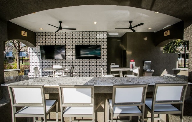 a bar with chairs and a counter in a restaurant
