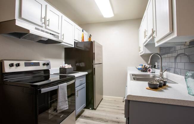 a kitchen with stainless steel appliances and white cabinets