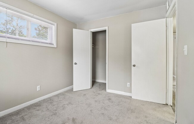 Step into spacious living at The Preserve On Conley Apartments. This stylish bedroom features cozy carpeting, ample natural light, and a minimalist design. Make this inviting space your own! Schedule your tour today to see it in person.