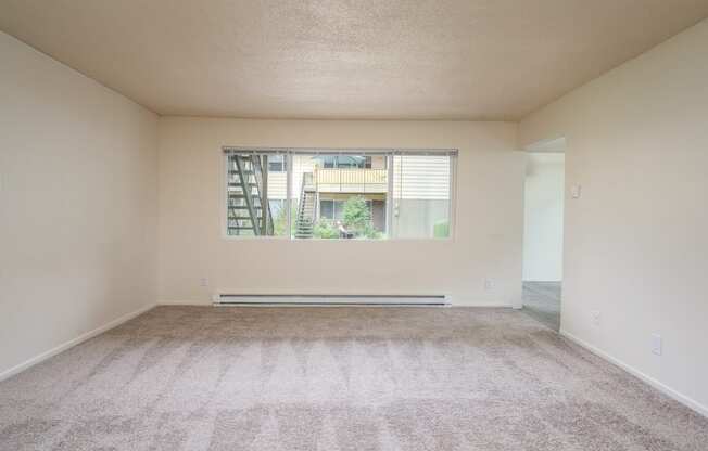 an empty bedroom with a large window