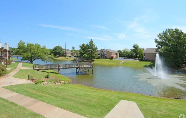 A park with a pond and a fountain.