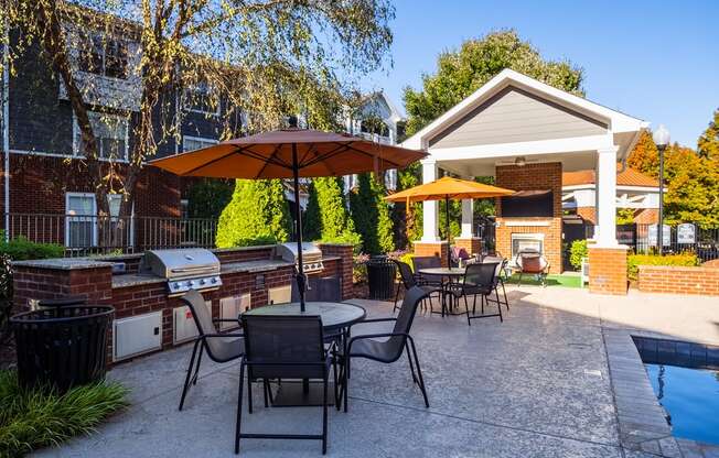 our apartments have a large patio with tables and umbrellas