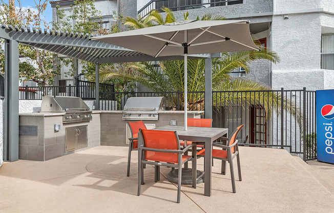 Outdoor BBQ Area with Furniture and Canopy at Crystal Creek Apartments in Phoenix, AZ.