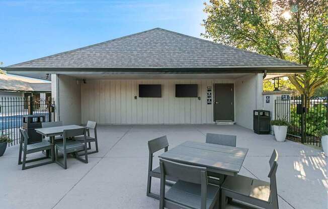 A patio with a table and chairs is set up outside a house.