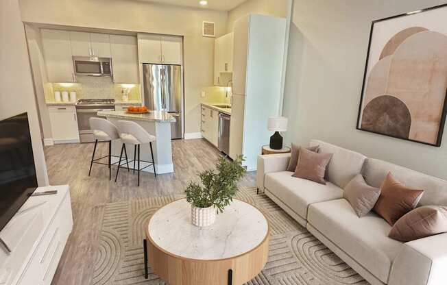 A modern living room with a white sofa and a wooden coffee table.