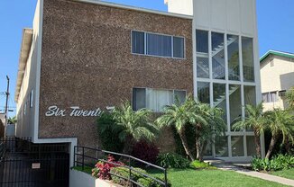 Signage, Garage, Building Front With Brick Detailing and Large Windows at Wilson Apartments in